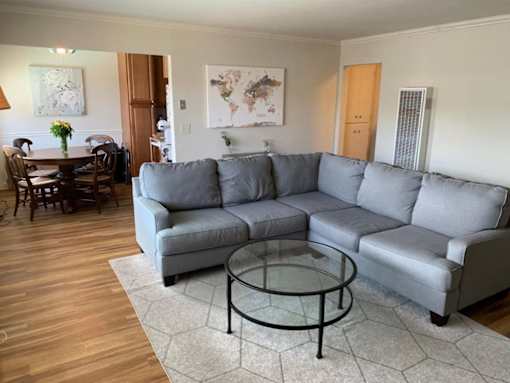 a living room with a couch and a glass coffee table