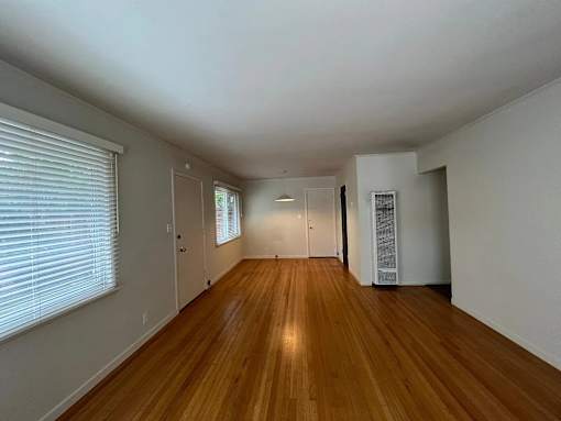 A room with wooden floors and white walls.