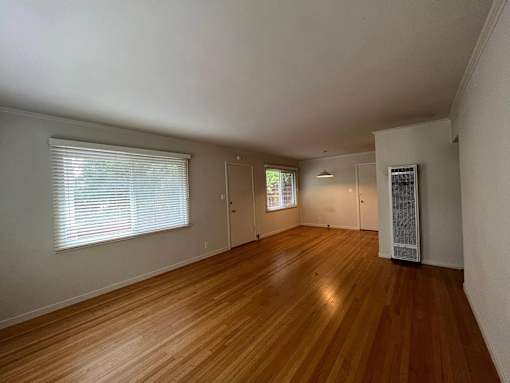 A room with wooden floors and white walls.