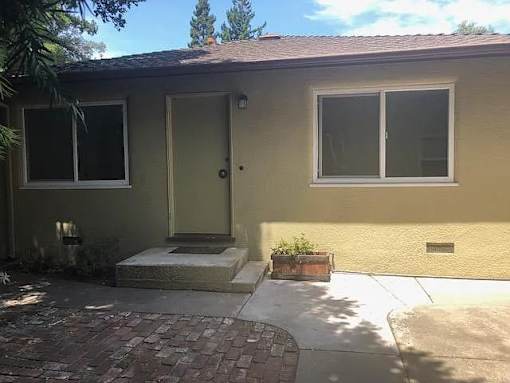A house with a grey door and a small porch.