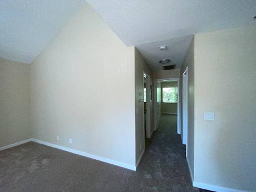 A long hallway with a door at the end.