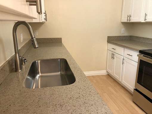 a kitchen with a sink and a wood floor