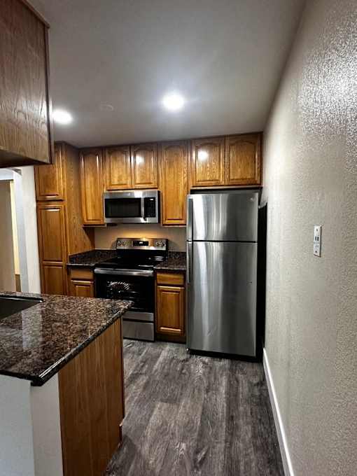 a kitchen with stainless steel appliances and wooden cabinets