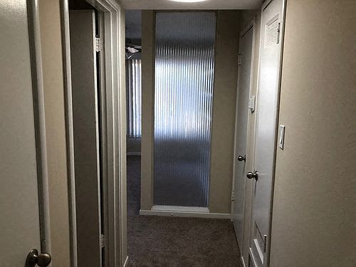 a hallway with a closet and a door