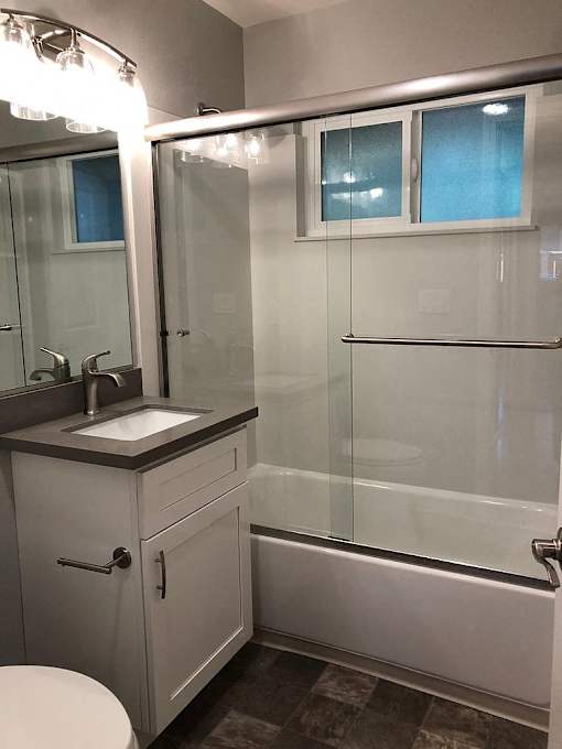 A bathroom with a sink, toilet, and shower.