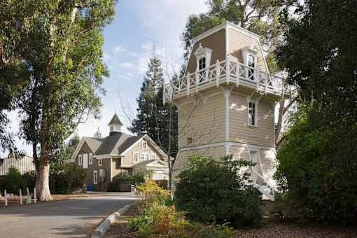 A house with a tower-like structure on the side.