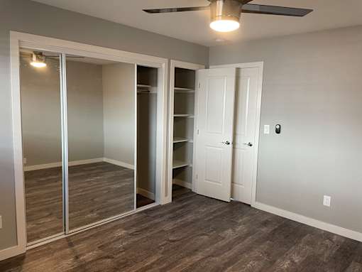 A room with a sliding door and a ceiling fan.