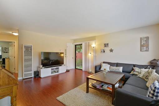 A living room with a grey couch and a coffee table.