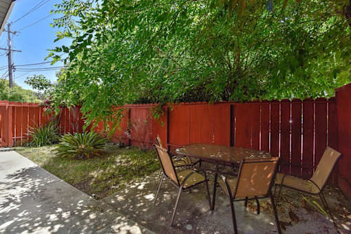 A table and chairs are set up in a backyard.
