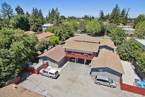 A large building with a parking lot in front of it.