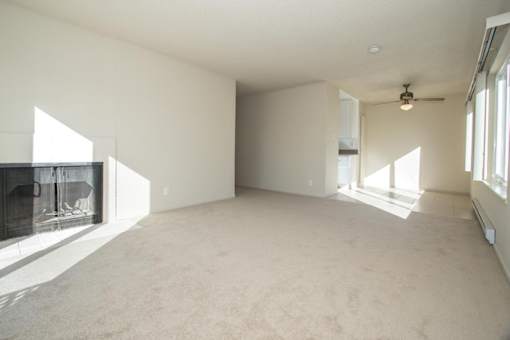 an empty living room with a fireplace