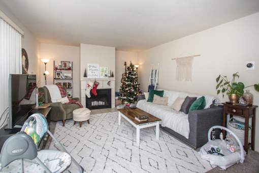 a living room with a christmas tree in the corner
