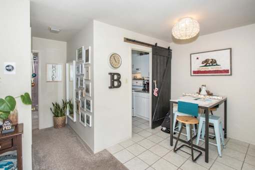 a dining room with a table and a door to a kitchen