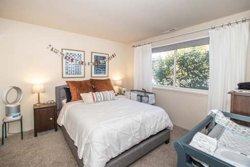 a room with three windows and a bed in it