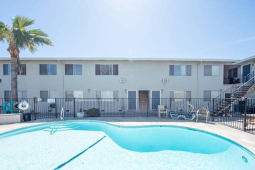 our apartments have a large pool and a building with a palm tree