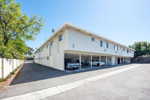a large white building with cars parked outside of it