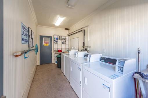 a laundry room with washes and dryers in it