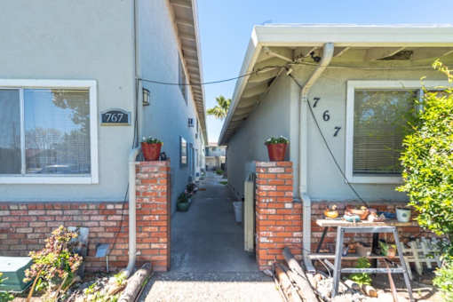 the front porch of a house with a table in front of it