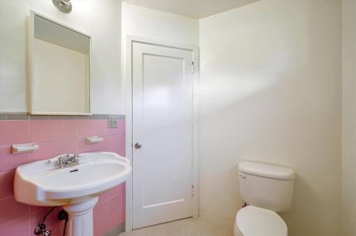 a bathroom with a sink toilet and a mirror
