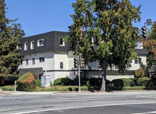 an apartment building on the corner of a street