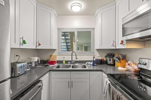 a kitchen with white cabinets and a sink