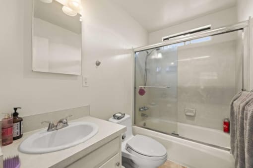 a bathroom with a sink toilet and a shower
