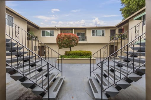 a set of stairs leading up to an apartment building