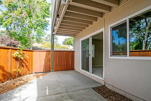 a patio outside a house with a sliding glass door