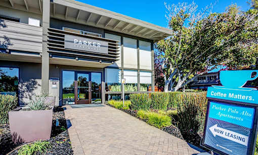 the entrance to a parker coffee makers building with a sign in front of it