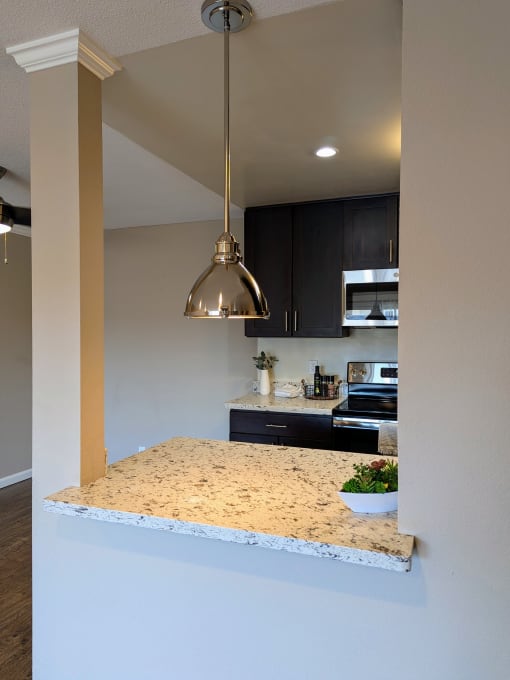 a view of a kitchen with a granite counter top