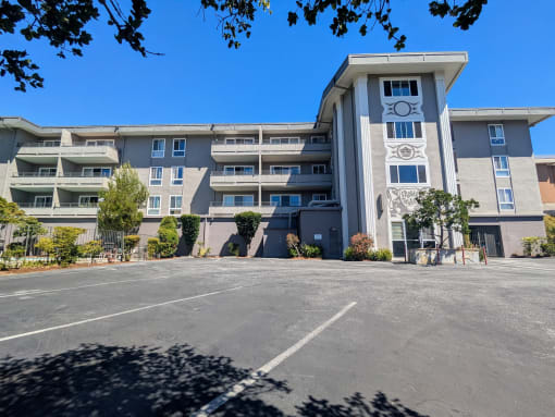 an apartment building with a clock tower in front of it