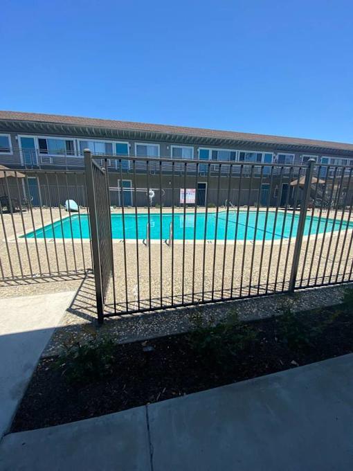 a swimming pool with a fence in front of it