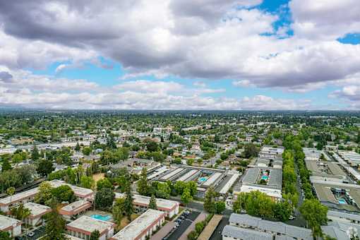 an aerial view of a city with many buildings and trees