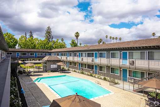 a view of a pool and a building with a swimming pool