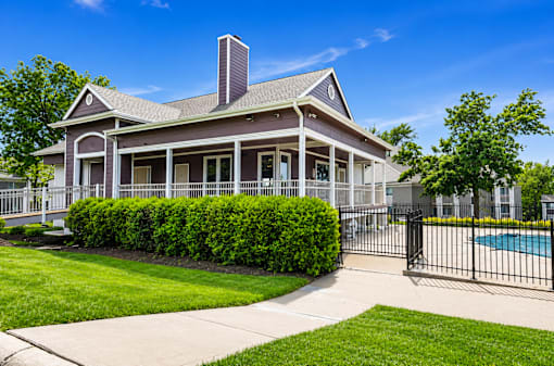 Clubhouse with a pool in the backyard.