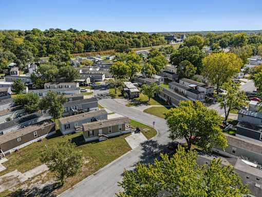 A bird's eye view of a residential area with houses and trees.