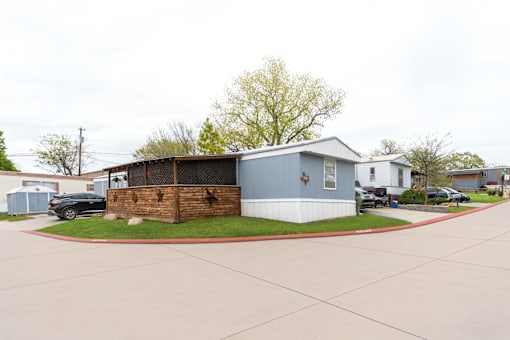 A blue house with a wooden fence in front.