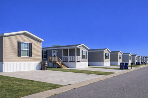 A line of houses with a clear blue sky above them.