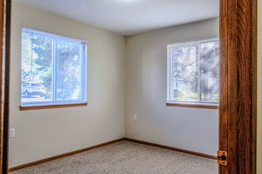 A room with a window and a door.