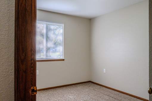 A room with a window and a door.