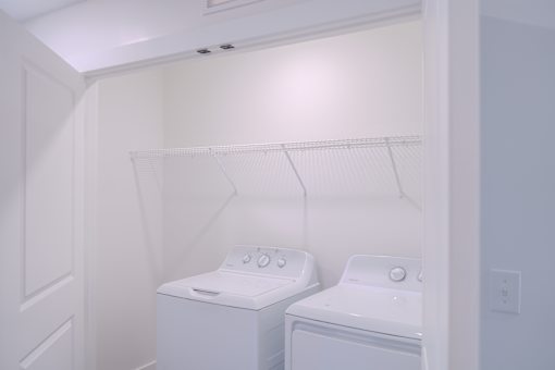 A small laundry room with a washer and dryer.