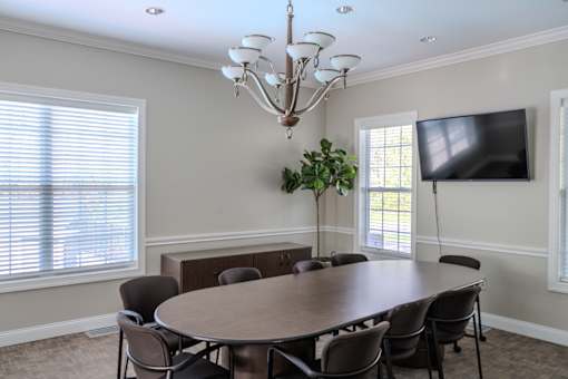 A dining room with a round table and chairs.