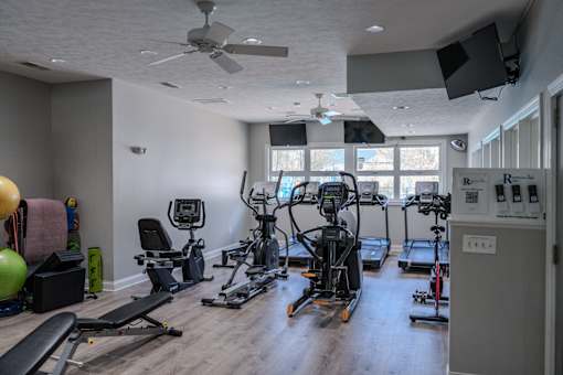 A spacious home gym with a variety of exercise equipment.