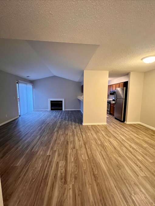A room with wooden flooring and a white ceiling.