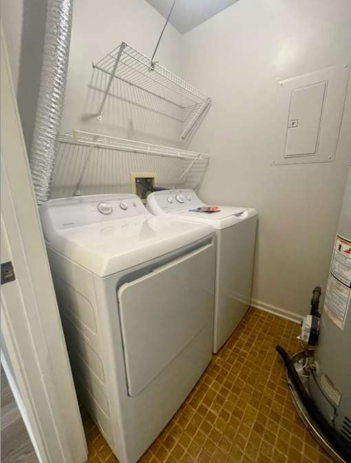 A small laundry room with a washer and dryer.