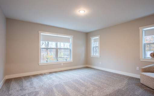 A room with two windows and a carpeted floor at Eden Forest Townhomes Apartments, Kentwood 