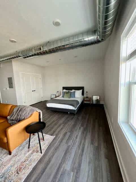 A room with a bed, a couch, and a chair at Michigan Street Apartment Homes, Michigan