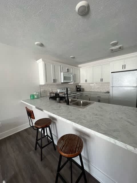 A kitchen with a white counter top and a refrigerator at Michigan Street Apartment Homes, Apartments, Grand Rapids  , MI