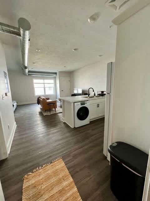 A kitchen with a washing machine and a dishwasher at Michigan Street Apartment Homes, Michigan, 49503