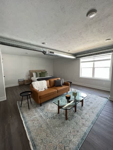 A living room with a couch, a coffee table, and a rug at Michigan Street Apartment Homes, Grand Rapids  , 49503